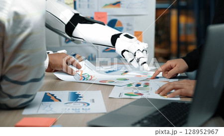 Collaboration between Human and Robot in Data Analysis, Showcasing Charts and Graphs to Enhance Business Decision-Making in Modern Workspace. Noogenesis 128952967