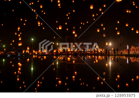 Fire Lanterns Floating up into the sky is reflection in the water at night at Loi Krathong Festival Travel Destinations Of Chiang Mai, Thailand. Fire Lanterns Floating up into the sky is reflection in the water at night at Loi Krathong Festival Travel Destinations Of Chiang Mai, Thailand. 128953875
