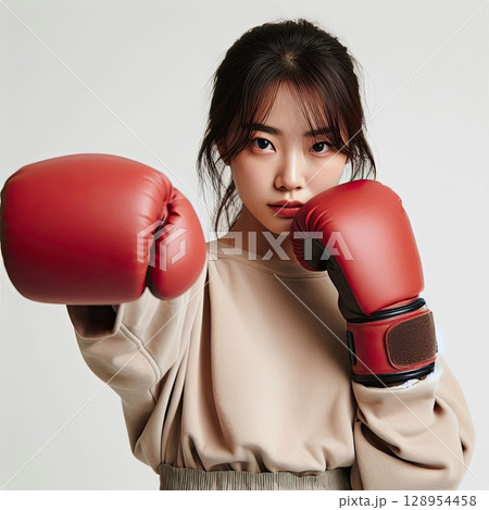 Confident Young Woman in Boxing Gloves Ready for Action with Generative AI. 128954458