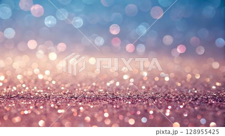 The image features a blurred bokeh effect with a gradient of blue and pink hues, with sparkling glitters concentrated toward the lower half of the 128955425