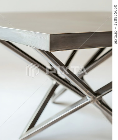 A silver table with a metal frame and a silver top A silver table with a metal frame and a silver top 128955650