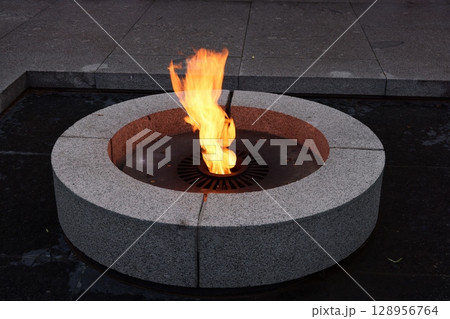 Eternal Flame amid Modern Surroundings, blending elements of architecture with contemporary art 128956764