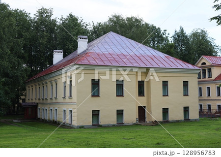A Historic Building Featuring a Unique Roof Design Nestled in a Serene and Beautiful Landscape 128956783