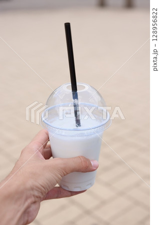 Enjoying a Refreshing Beverage in Hand While Relaxing on a Beautiful Sunny Day Outside 128956822