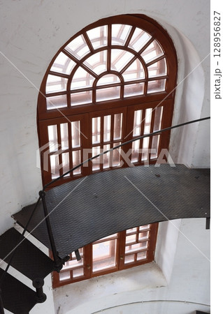 This architectural masterpiece features an elegant spiral staircase and a striking arched window 128956827