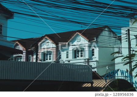 Charming Colonial Architecture Gracing the Space Below Power Lines in an Urban Setting 128956836