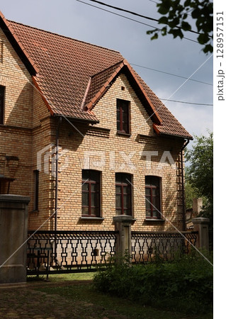 This Charming Brick Residence Features a Beautiful Garden and Captivating Elegant Design 128957151