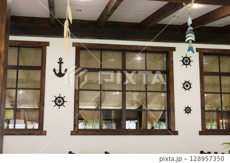 Experience the Cozy and Inviting Interior Featuring Nautical Theme Decor and Expansive Large Windows Experience the Cozy and Inviting Interior Featuring Nautical Theme Decor and Expansive Large Windows 128957350