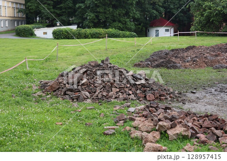 Excavation Site with Numerous Piles of Broken and Crumbling Bricks and Debris Nearby Excavation Site with Numerous Piles of Broken and Crumbling Bricks and Debris Nearby 128957415