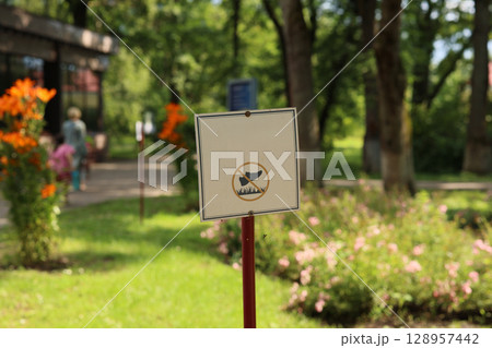 Signage Providing Important Rules and Regulations in a Beautiful Lush Park Setting Signage Providing Important Rules and Regulations in a Beautiful Lush Park Setting 128957442