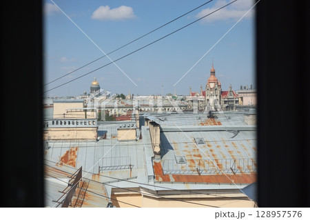A stunning city rooftop view showcasing historic architecture brilliantly under a clear blue sky A stunning city rooftop view showcasing historic architecture brilliantly under a clear blue sky 128957576