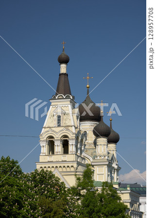 An Iconic Orthodox Church with Its Distinctive Domes Set Against a Clear Blue Sky An Iconic Orthodox Church with Its Distinctive Domes Set Against a Clear Blue Sky 128957708