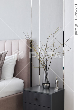 Elegant Bedroom Decor with a Chic Nightstand and Decorative Branches to Enhance Your Space 128957751