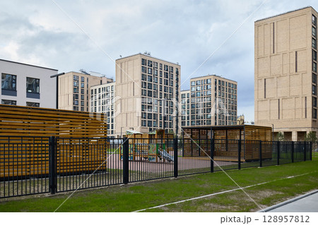 A modern urban playground integrated with residential buildings enhances community living 128957812