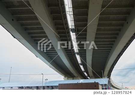 Beneath the Structure of a Modern Overpass that Enthralls and Encompasses Urban Life 128957824