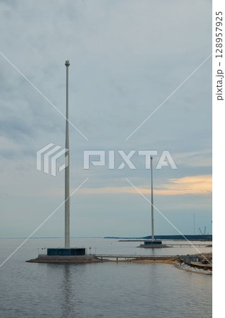 Tall Communication Towers Positioned by the Serene Water, Enhancing Connectivity and Navigation 128957925