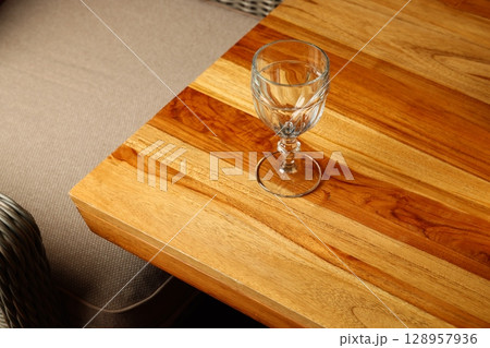 An Elegant Glass Set Beautifully Placed on a Wooden Table Creates a Stunning Display 128957936