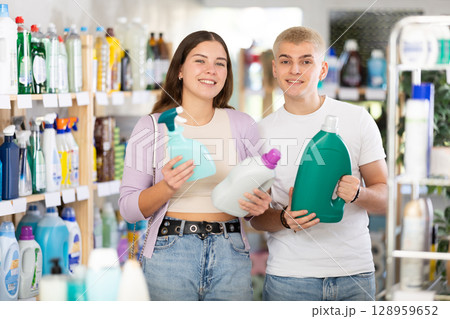 Couple man and woman choosing detergent and spray in store 128959652