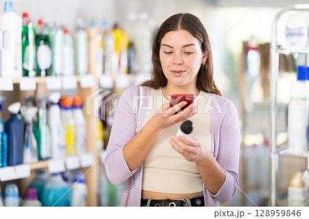 Young woman scanning qr code for deodorant 128959846
