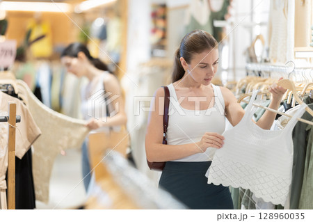 woman chooses stylish summer clothes woman chooses stylish summer clothes 128960035