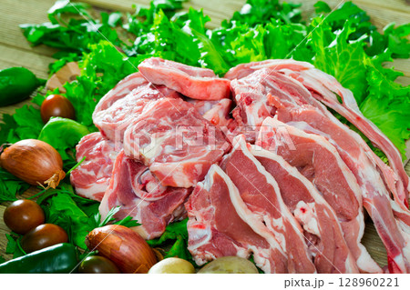 Raw lamb meat with vegetables Raw lamb meat with vegetables 128960221