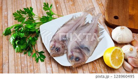 Two whole fresh megrims with seasonings 128960495