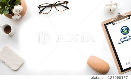 Workspace with a clipboard, glasses, coffee, and plant on a minimalist desk with blank space 128960577
