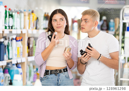 Young couple choosing perfume in department store 128961298
