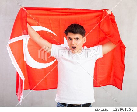 Surprised young guy holding Turkey flag 128961350