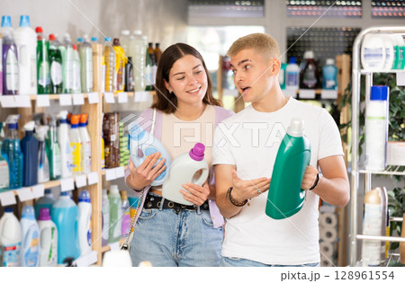 Young couple choosing laundry detergent in department store Young couple choosing laundry detergent in department store 128961554