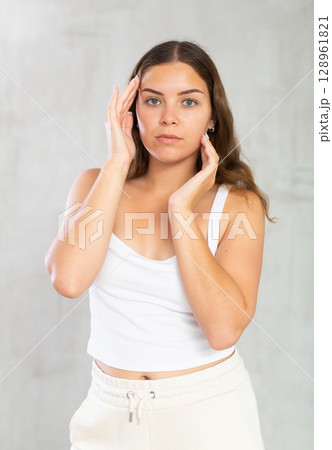 Portrait of pretty young woman in casual clothes posing in studio 128961821