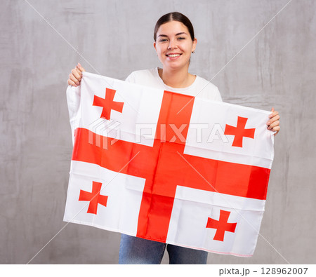 Happy girl stands with flag of Georgia.Isolated Happy girl stands with flag of Georgia.Isolated 128962007
