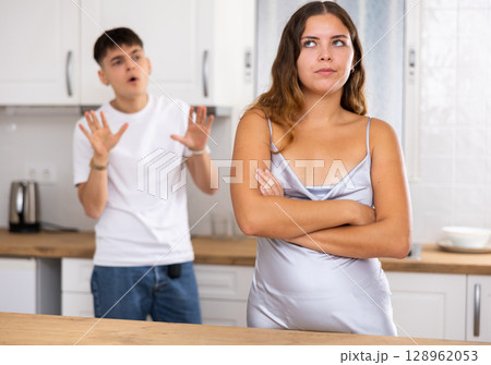 Young husband is dissatisfied with the act of his wife Young husband is dissatisfied with the act of his wife 128962053