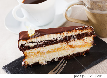 Piece of chocolate lemon cake on black board Piece of chocolate lemon cake on black board 128962088