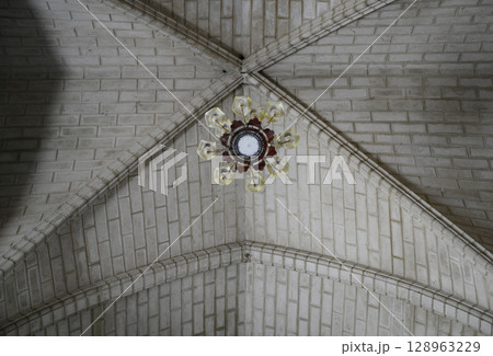 The arched Gothic ceiling of the Catholic Cathedral with a chandelier in Nha Trang, Vietnam 128963229