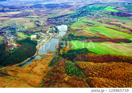 Aerial view of autumn Stradch village, church of Assumption of Blessed Virgin Mary, lake and pine forests in Ukraine Aerial view of autumn Stradch village, church of Assumption of Blessed Virgin Mary, lake and pine forests in Ukraine 128965739