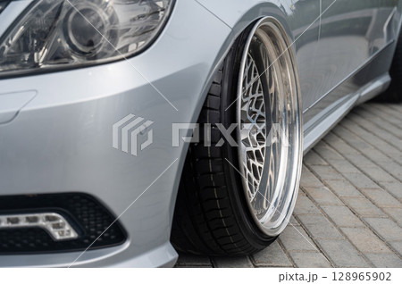 Close-Up of Custom Car Wheel and Tire Excellence. Close-Up of Custom Car Wheel and Tire Excellence. 128965902