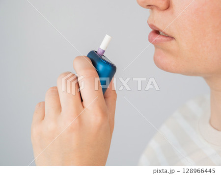 Caucasian woman smoking electronic cigarette. Tobacco heating system. Caucasian woman smoking electronic cigarette. Tobacco heating system. 128966445