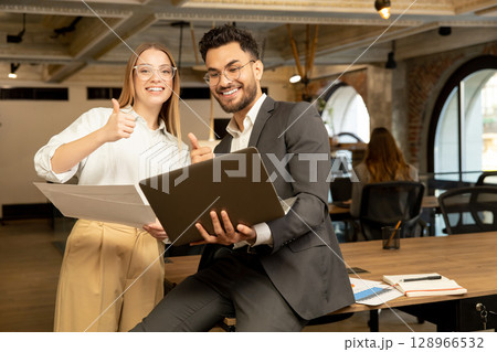 Colleagues discussing something and looking joyful and excited 128966532