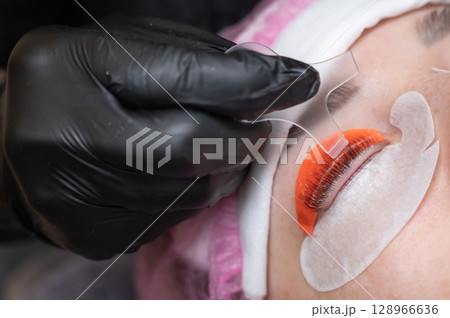 Caucasian woman undergoing eyelash lamination procedure.  128966636