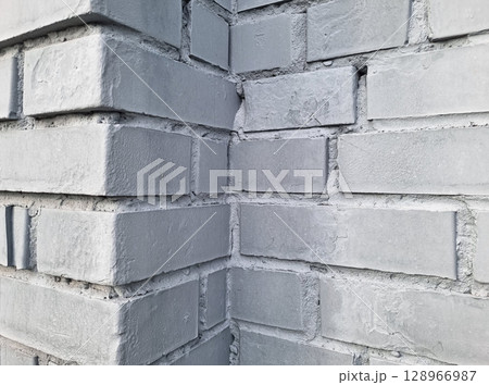 Corner of a gray brick wall texture with rough surface. 128966987