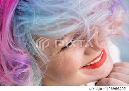 Close-up portrait of Caucasian woman with multi-colored hairstyle.  128966995