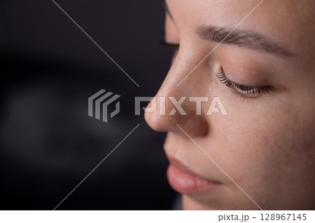 Close-up portrait of a woman after eyelash lamination procedure.  128967145