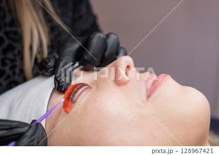 Caucasian woman undergoing eyelash lamination procedure.  128967421