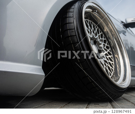 Close-Up of Custom Car Wheel and Tire Excellence. Close-Up of Custom Car Wheel and Tire Excellence. 128967491