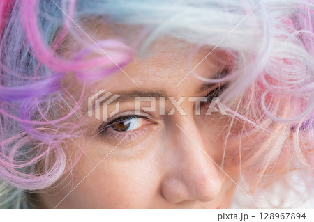 Close-up portrait of Caucasian woman with multi-colored hairstyle. Close-up portrait of Caucasian woman with multi-colored hairstyle. 128967894