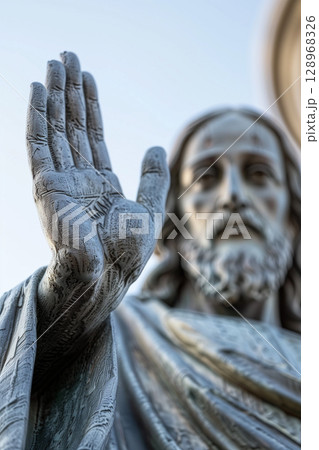 Close-up low angle view of a bronze statue of Jesus Christ with raised hand 128968326