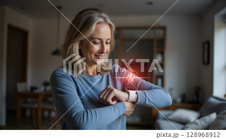 Woman Monitoring Heart Rate with Smartwatch in Cozy Living Room Environment 128968912