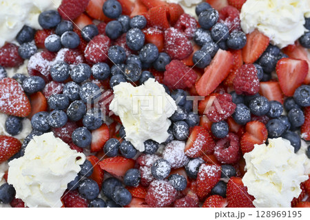 Delicious strawberry tart with blueberries, fresh raspberries and whipped cream, cheesecake, top Delicious strawberry tart with blueberries, fresh raspberries and whipped cream, cheesecake, top 128969195