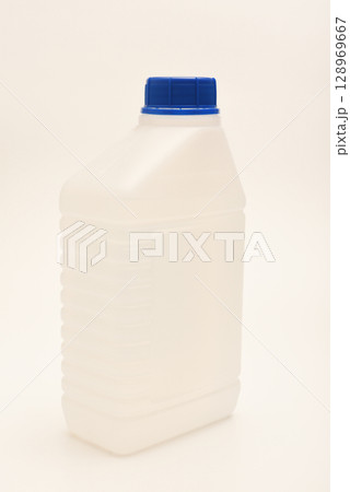 A white plastic container with a blue lid. A small plastic canister. A container with liquid. 128969667